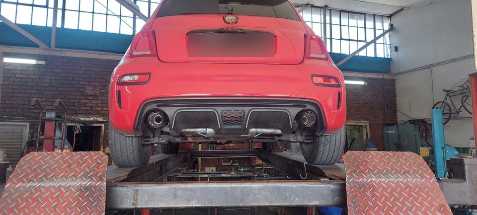 Red Abarth on the ramp showing twin exhaust tips