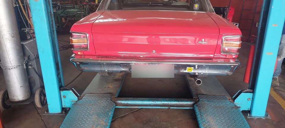 Classic red Ford Fairmont on the lift